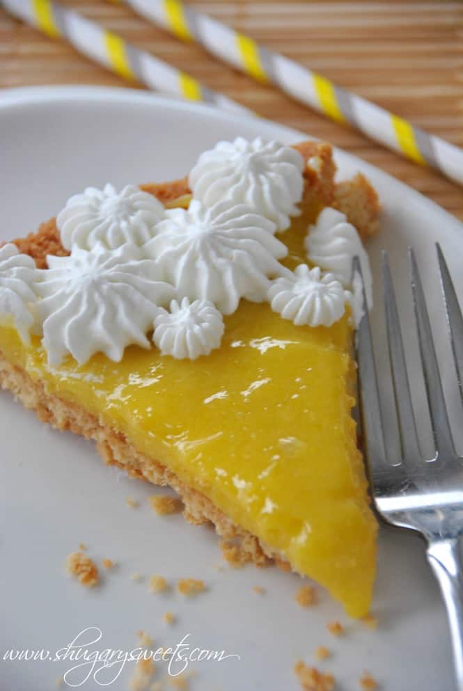 Lemon Tart with Macadamia Nut Crust: shortbread macadamia nut crust topped with homemade lemon curd and whipped cream #lemontart #dessert www.shugarysweets.com Lemon Tart with Macadamia Nut Crust: shortbread macadamia nut crust topped with homemade lemon curd and whipped cream #lemontart #dessert www.shugarysweets.com