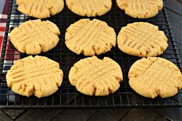 Perfect Peanut Butter Cookies. Soft and chewy, easy to make, and topped with a sweet sugar coating. You're going to love this delicious recipe! Baked peanut butter cookies on a black wire rack.