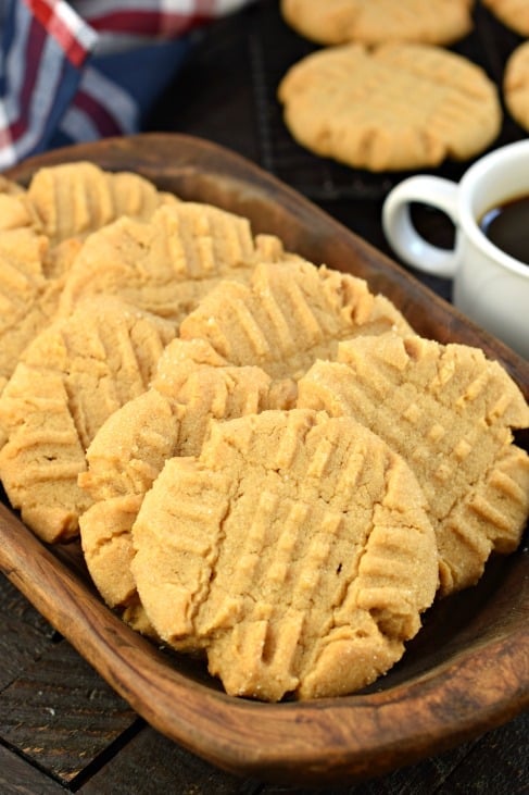 Perfect Peanut Butter Cookies. Soft and chewy, easy to make, and topped with a sweet sugar coating. You're going to love this delicious recipe! Peanut Butter Cookies on wooden plate