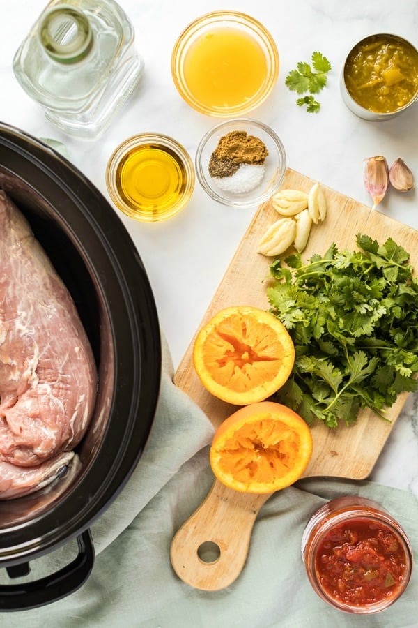 Ingredients needed to make carnitas in the crockpot.