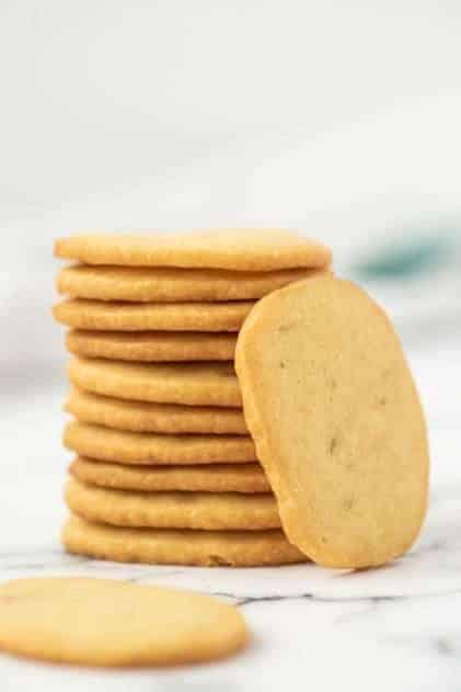 Stack of shortbread cookies on marble surface.