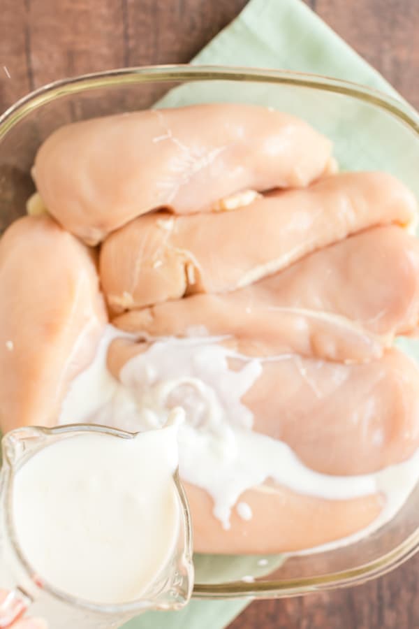 Raw Chicken in a glass bowl with milk