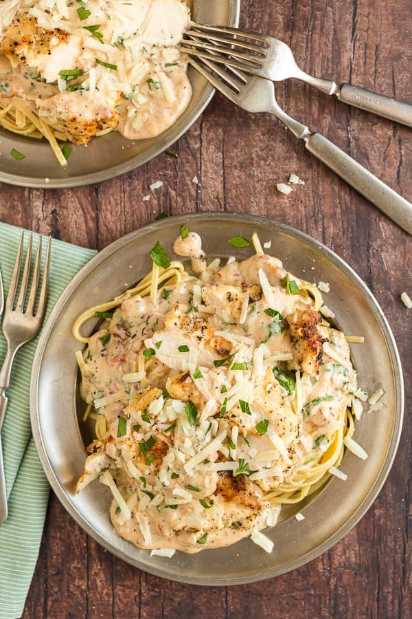 Two silver bowls with creamy italian chicken pasta