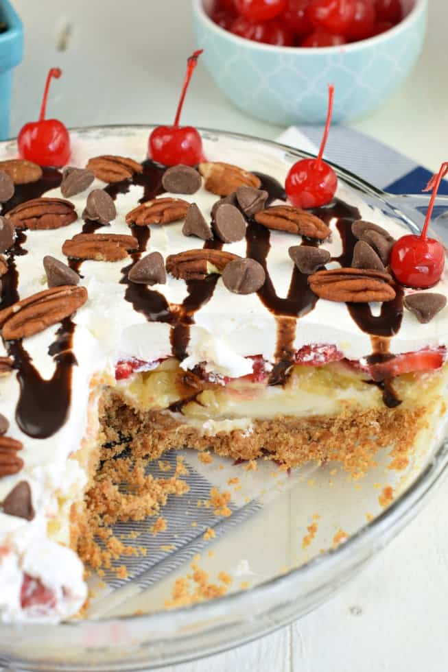 Pie plate with a piece of banana split cheesecake removed.