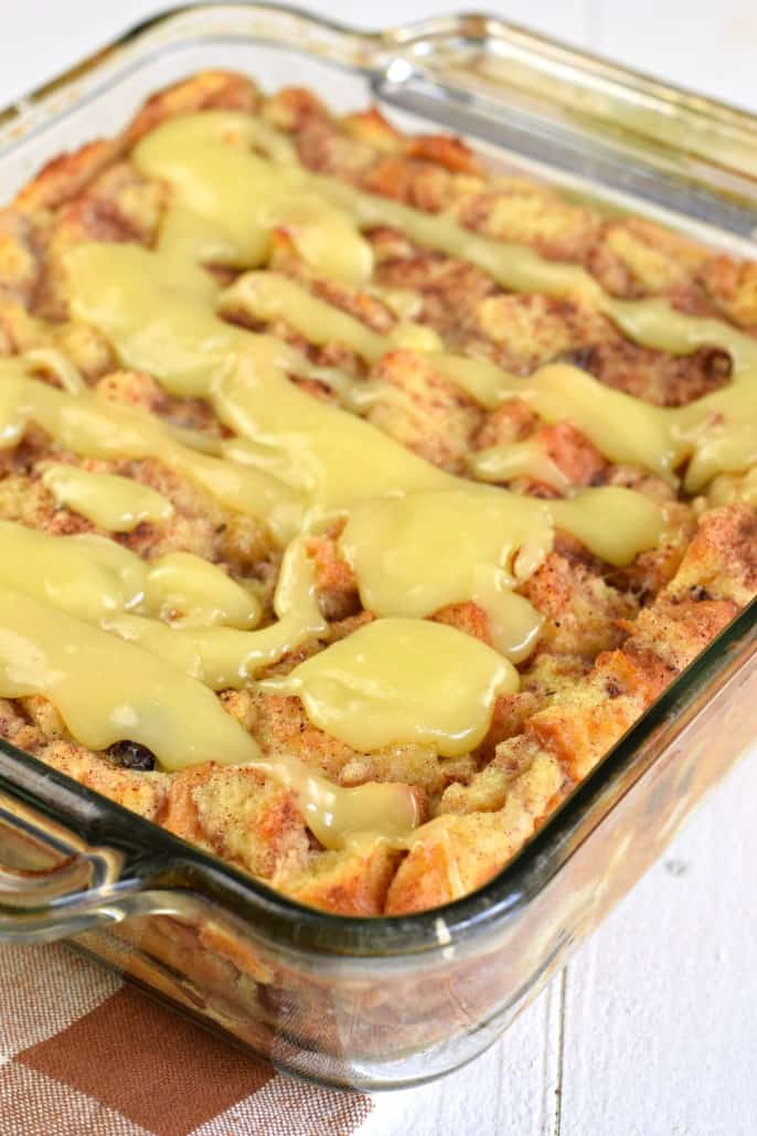 Glass 13x9 baking dish with bread pudding topped with lemon glaze.