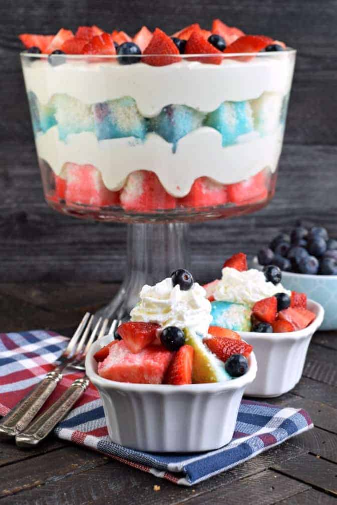 Jell-O Cheesecake Trifle recipe is an easy dessert made with a festive poke cake, cheesecake filling, and fresh berries. Perfect holiday dessert!