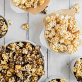 White and dark chocolate covered caramel corn in bowls.