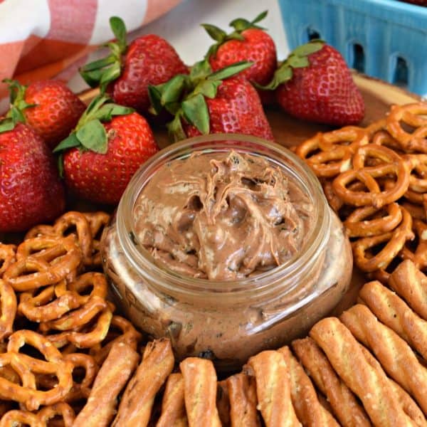 Oreo chocolate dip with peanut butter mixed in served with strawberries and pretzels.