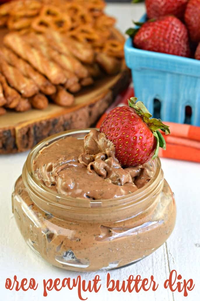 Strawberry dipped in a small mason jar of oreo peanut butter dip.