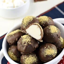 S'more truffles in a white bowl, one cut in half.