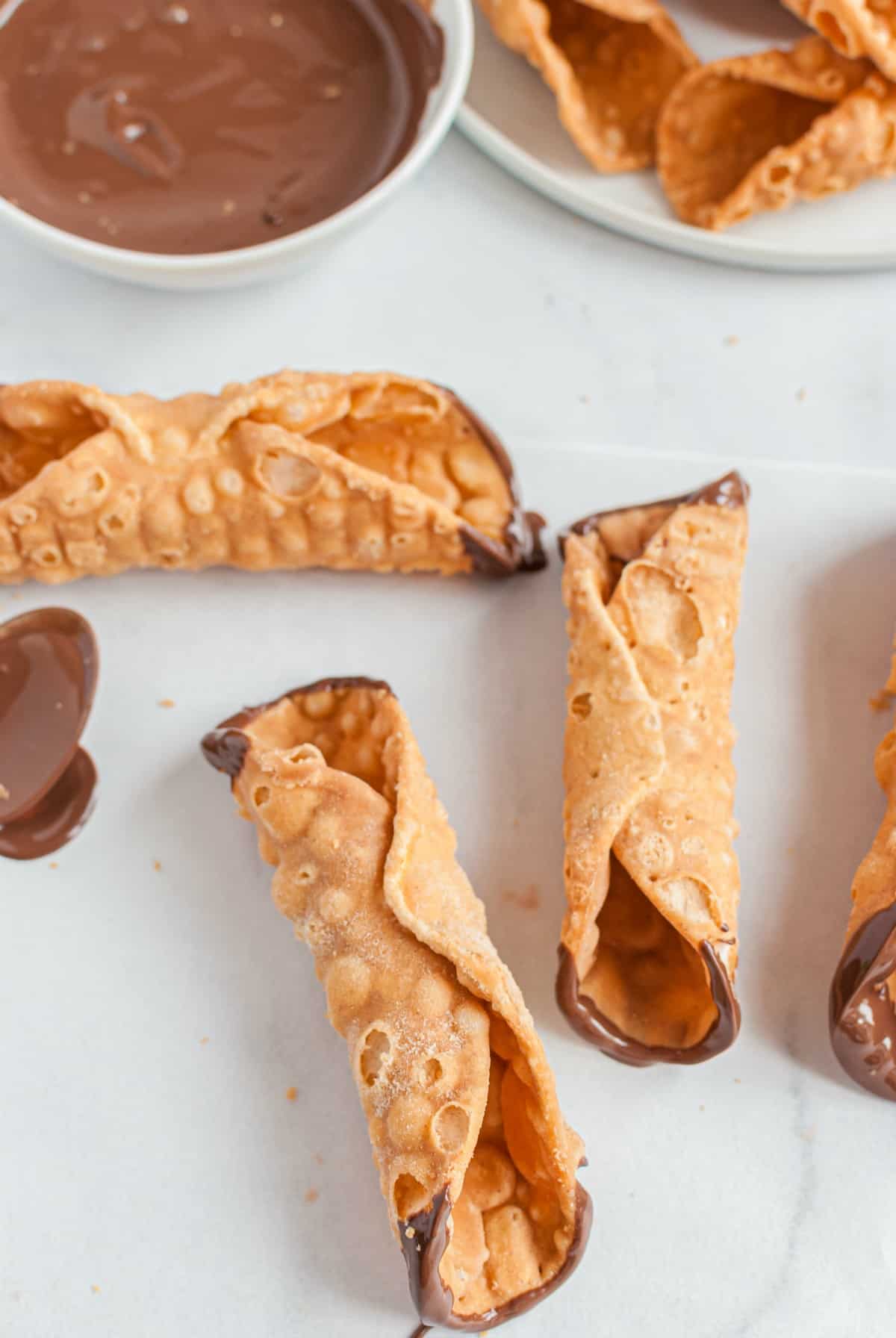 Cannoli shells dipped in chocolate.