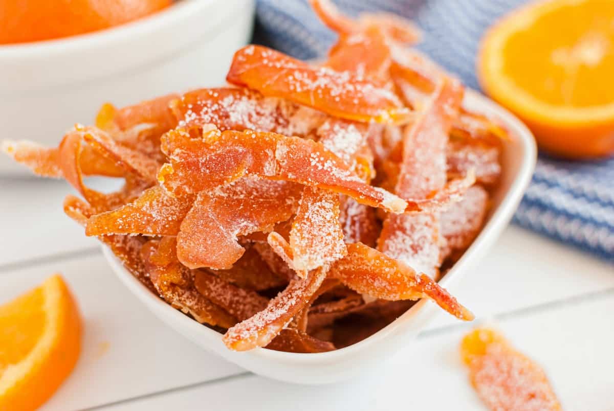 Homemade orange peel candy in a white serving bowl.