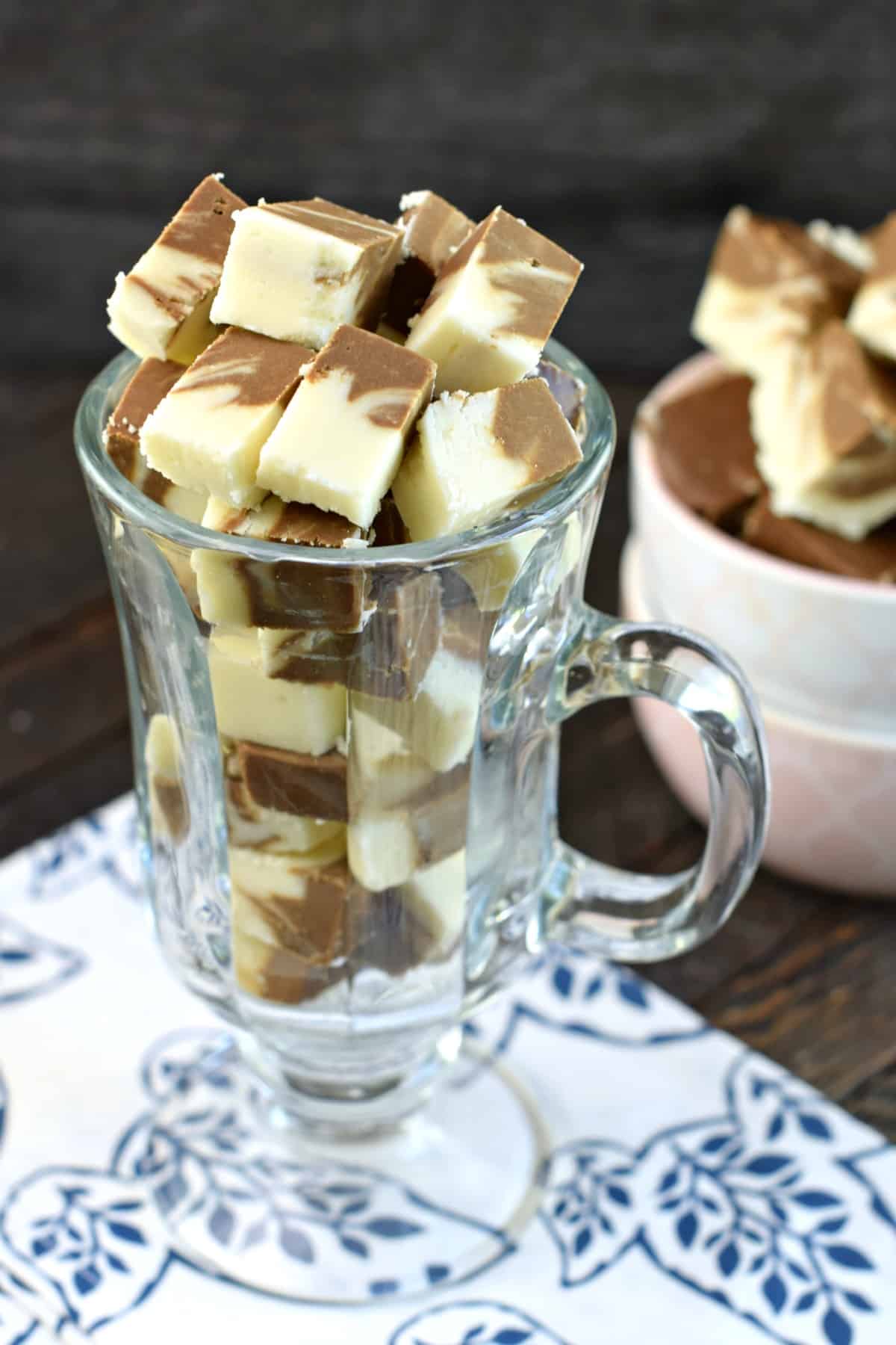 Clear glass mug with pieces of root beer fudge.