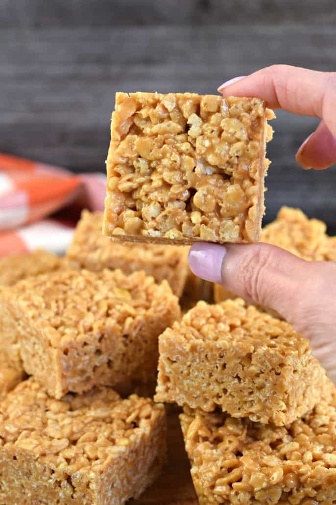 Square of biscoff rice krispie treat being held.