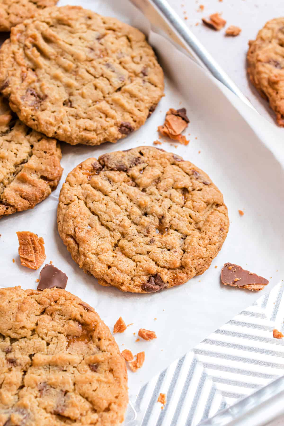 Butterfinger cookies baked on a sheet pan with parchment paper.