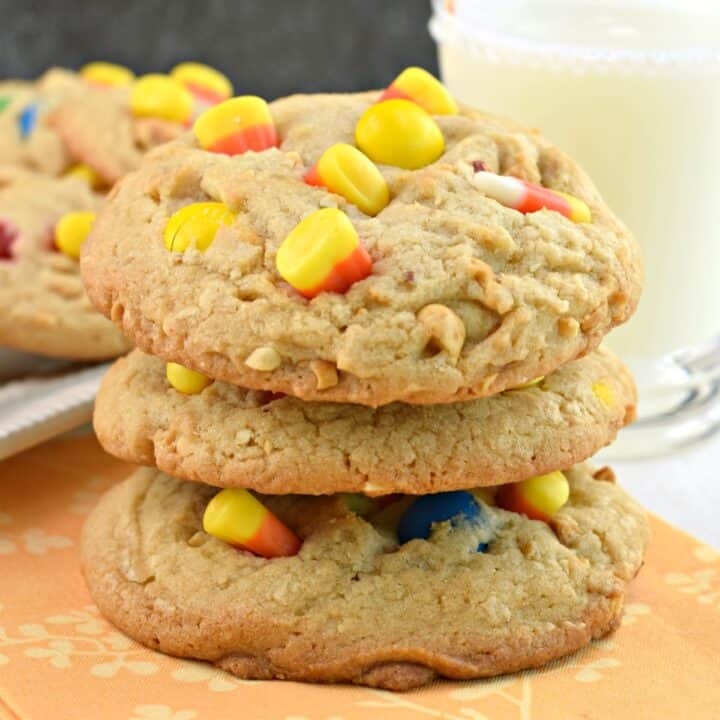 Stack of three peanut butter cookies with candy corn, peanuts, and M&M'S.