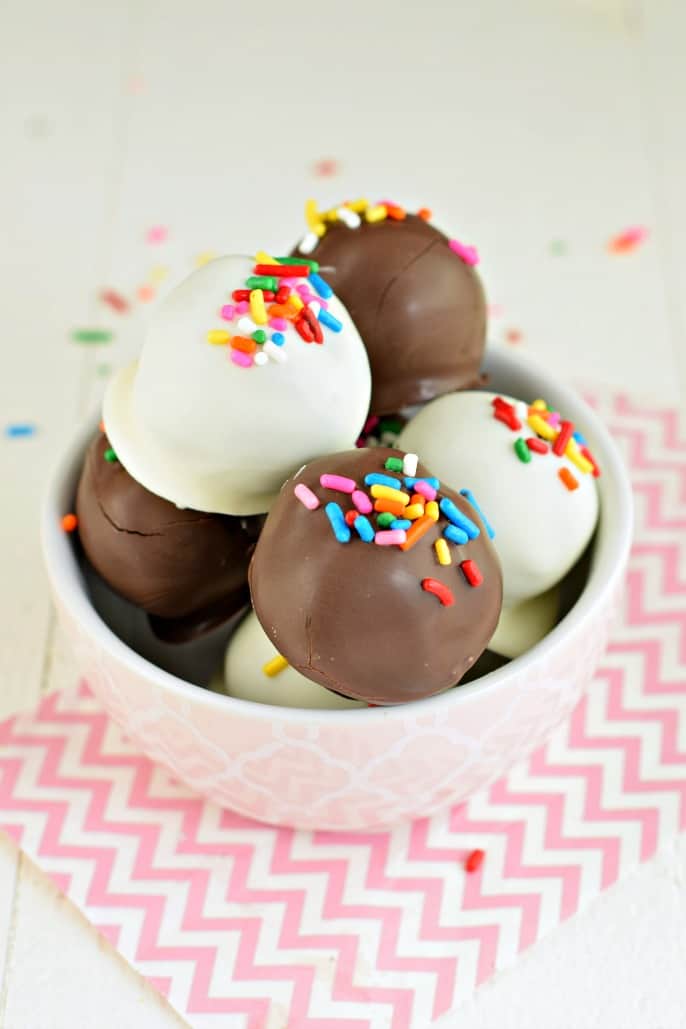 White Chocolate and Dark Chocolate Oreo Truffles with festive sprinkles in pink bowl