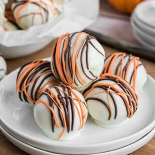 Pumpkin pie truffles served on a white plate.