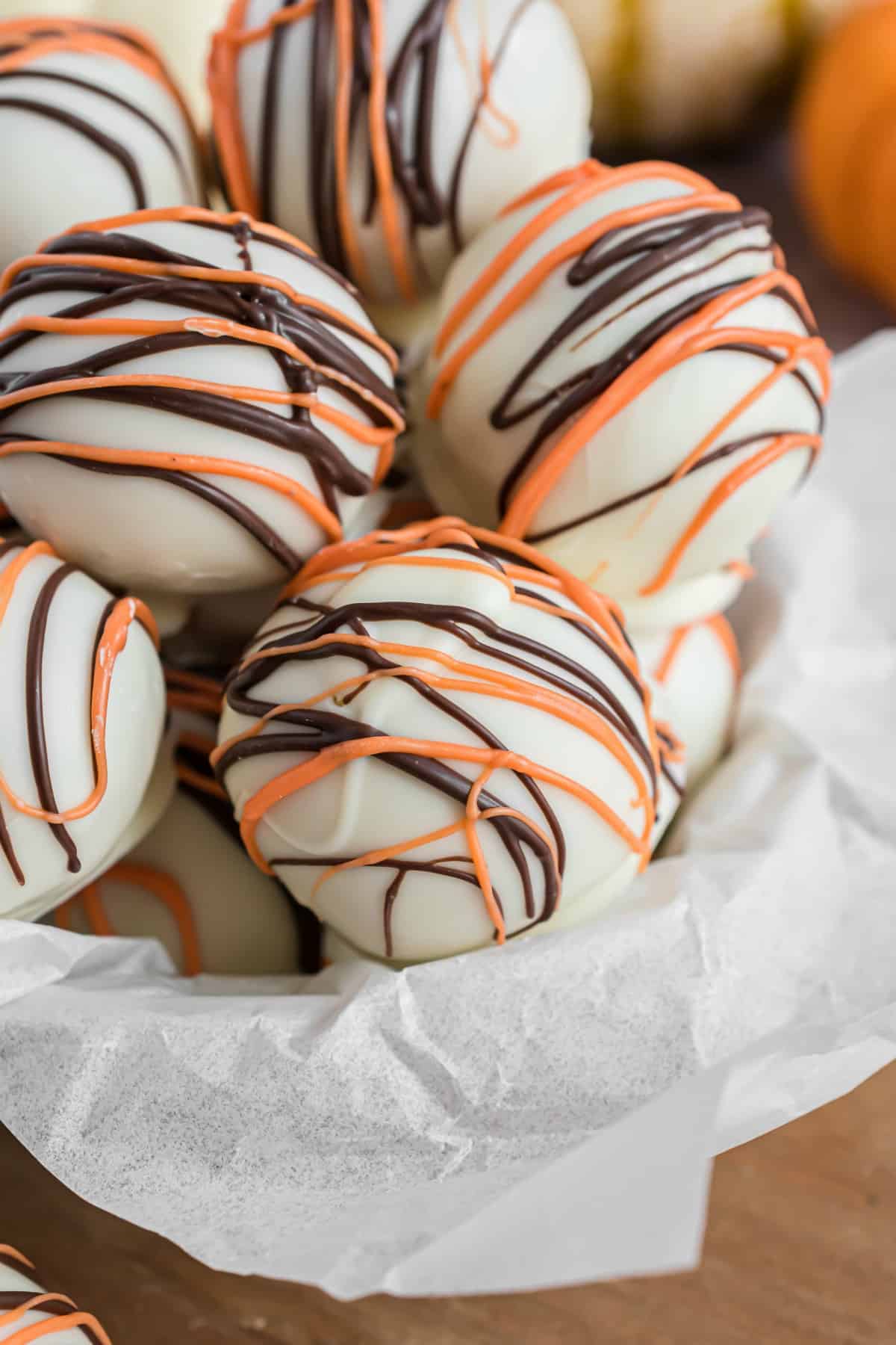 Pumpkin pie truffles in a parchment paper lined bowl.