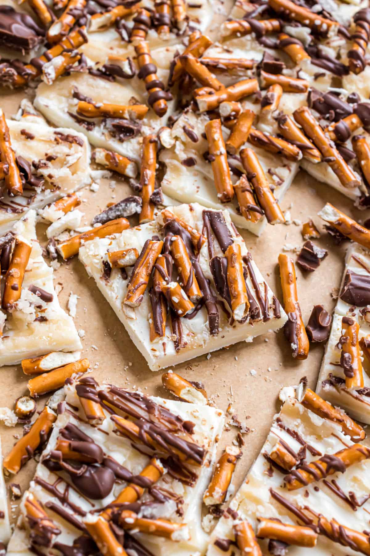 White chocolate topped with salted caramel, pretzels, and milk chocolate, cut into pieces.