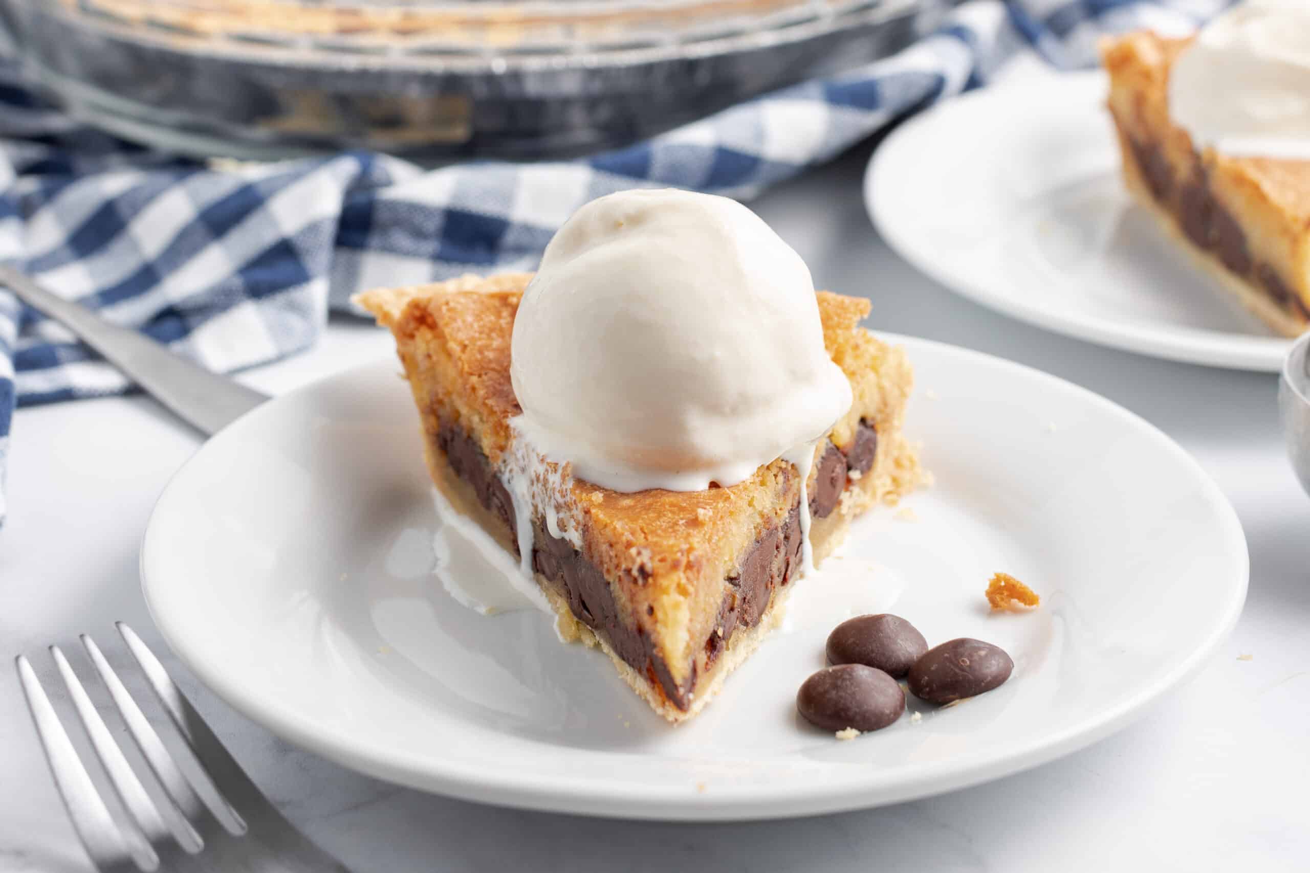 Pie with chocolate chip cookie dough baked in the filling topped with vanilla ice cream.