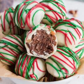 Bowl of almond truffles dipped in white chocolate and christmas chocolate.