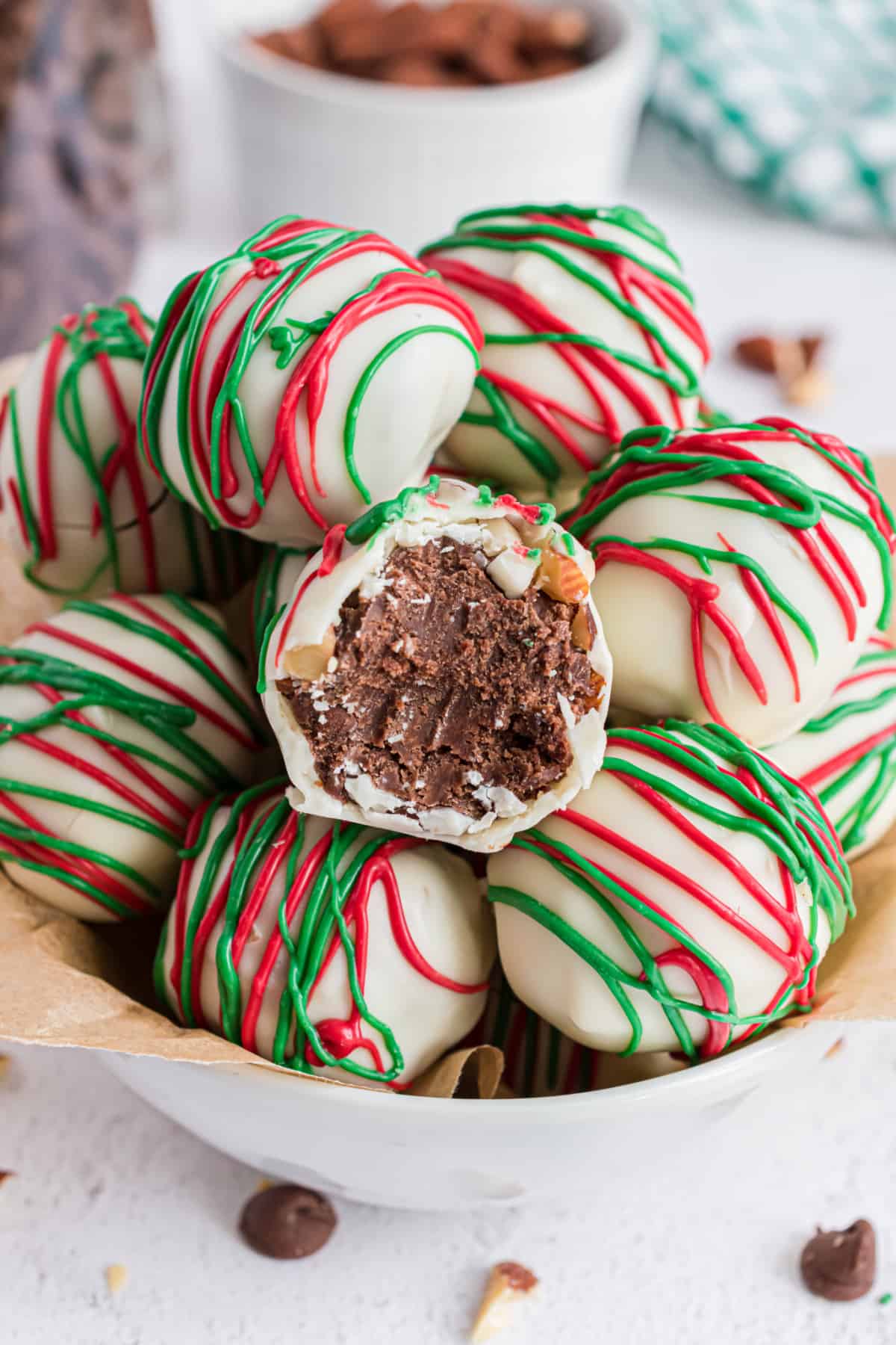 Bowl of almond truffles dipped in white chocolate and christmas chocolate.