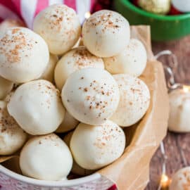 Love homemade truffles? These Eggnog Truffles are made with real eggnog in the creamy center and topped with white chocolate and a pinch of nutmeg. Easy and delicious.
