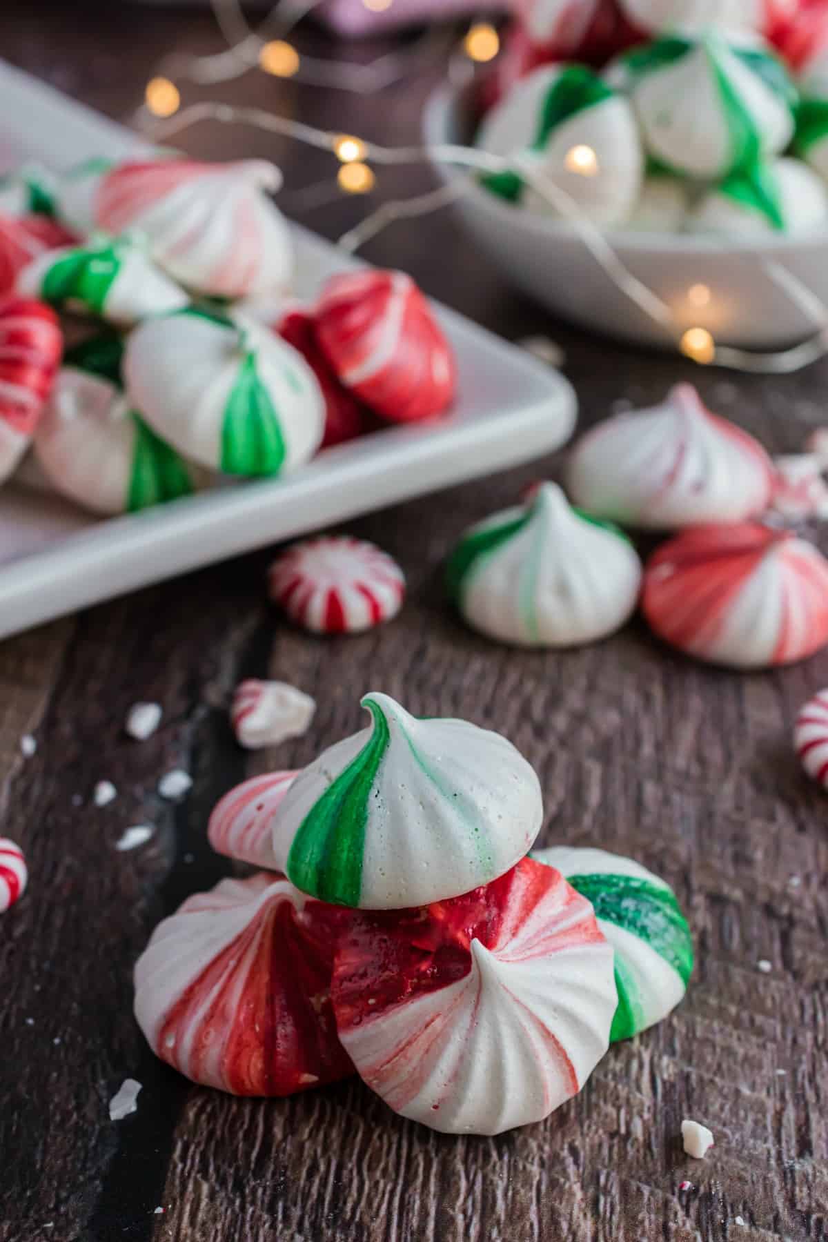 Stack of mint meringues on wooden table.
