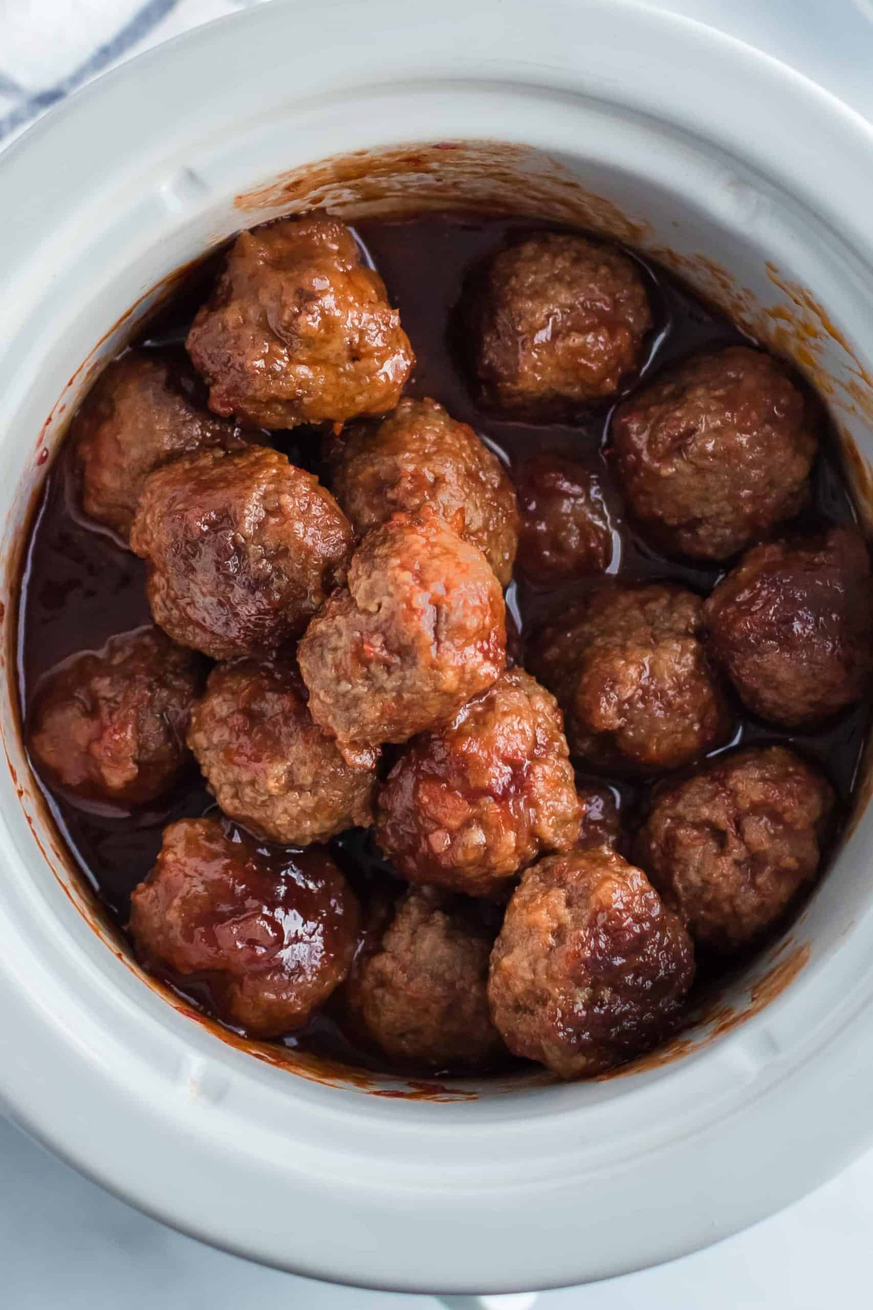 Crockpot with grape jelly meatballs in sauce.