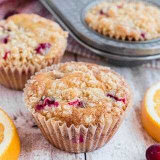 Cranberry Orange muffin with streusel on counter.