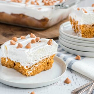 Two slices of butterscotch cake on a white dessert plates.