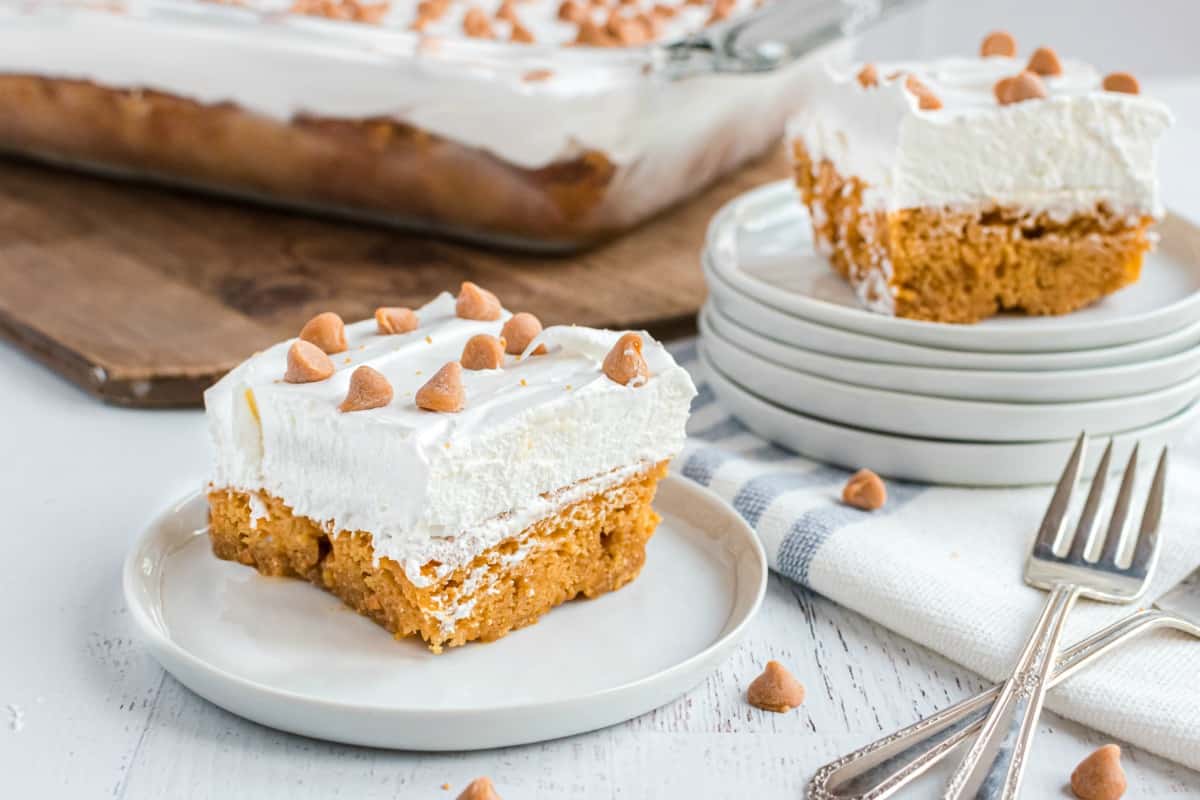 Two slices of butterscotch cake on a white dessert plates.