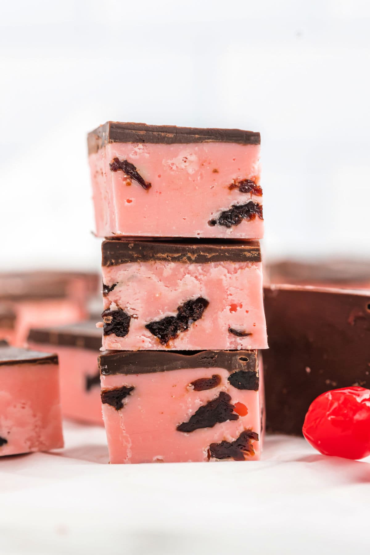 Stack of three pieces of cherry fudge.