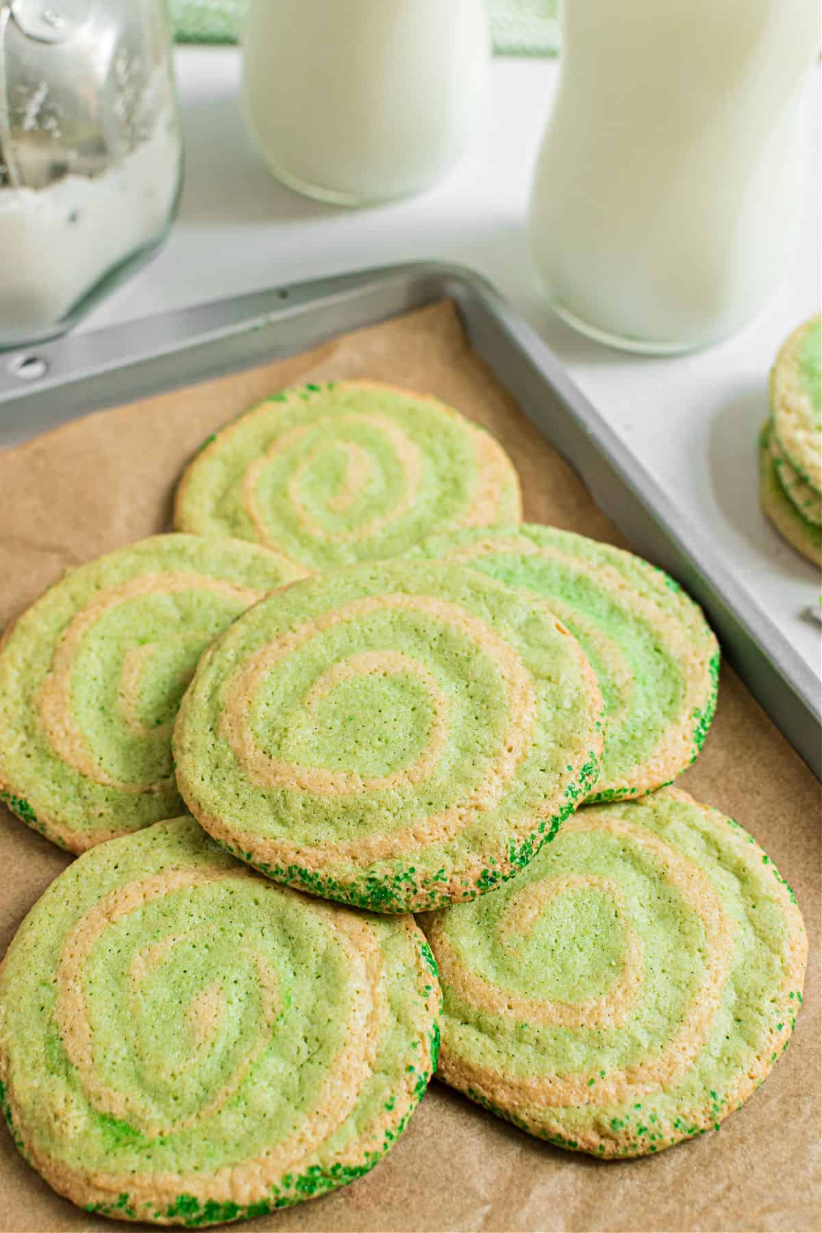 Stack of baked icebox swirled cookies on a parchment paper lined baking sheet.