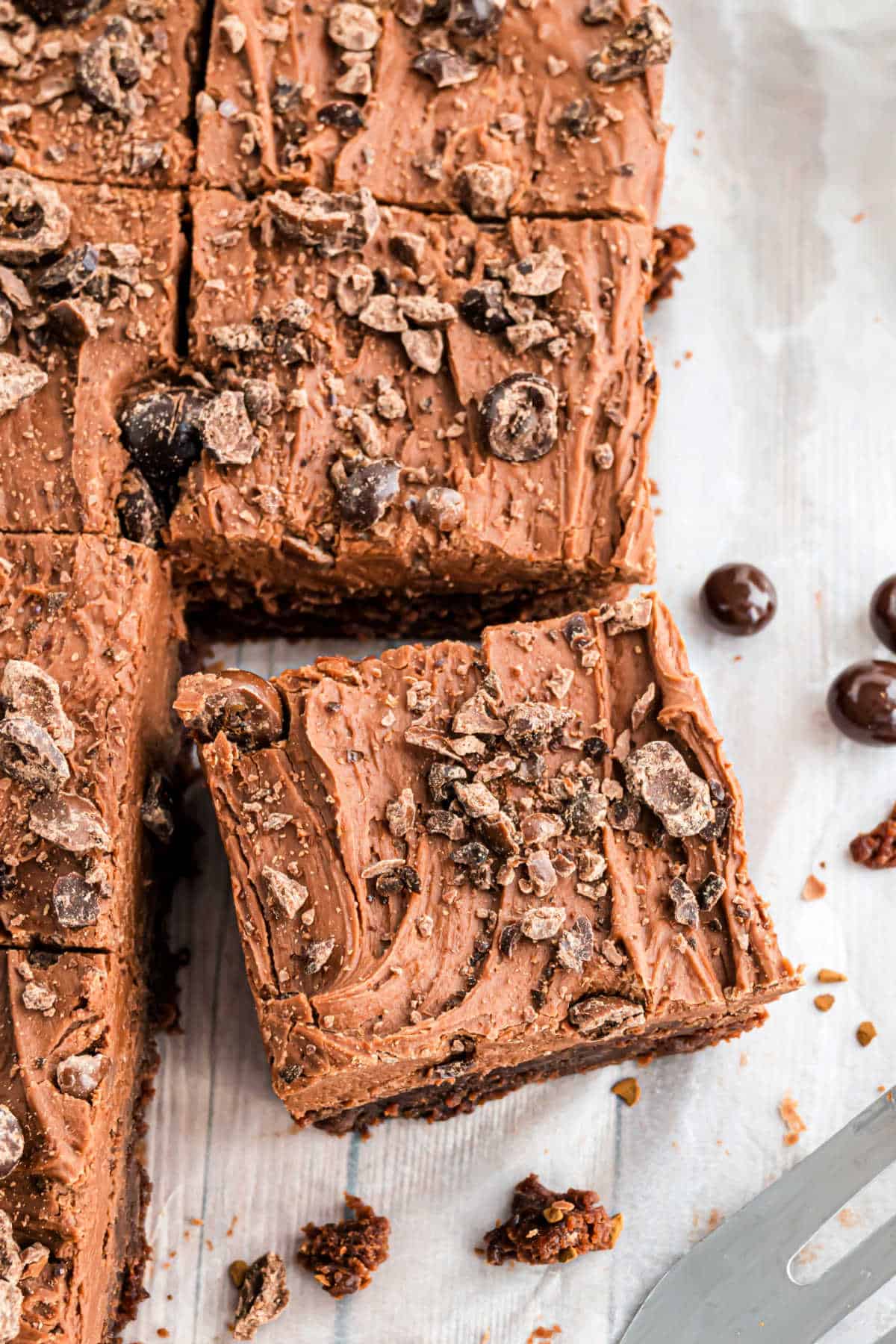 Pan of frosted brownies with one cut and removed.