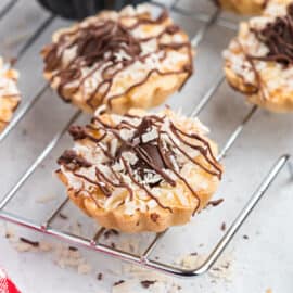 What do you do when you're craving Samoa Cookies but there's not a girl scout in site? Make this copycat girlscout cookie recipe at home! They may look different, but these Coconut Kiss Cookies have all the key flavors!