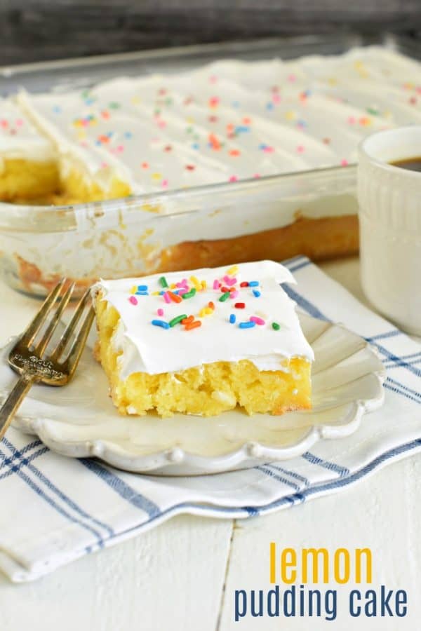 Slice of lemon pudding cake on a plate with cake in background.