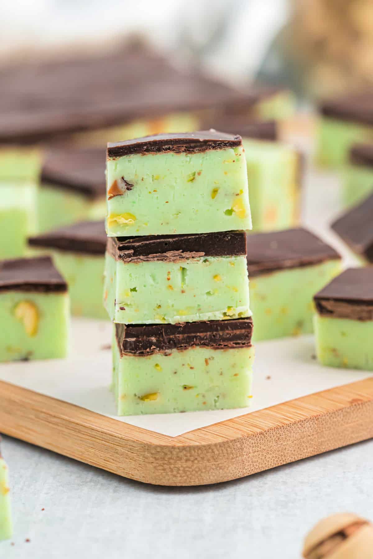 Three pieces of pistachio fudge stacked on top of each other.