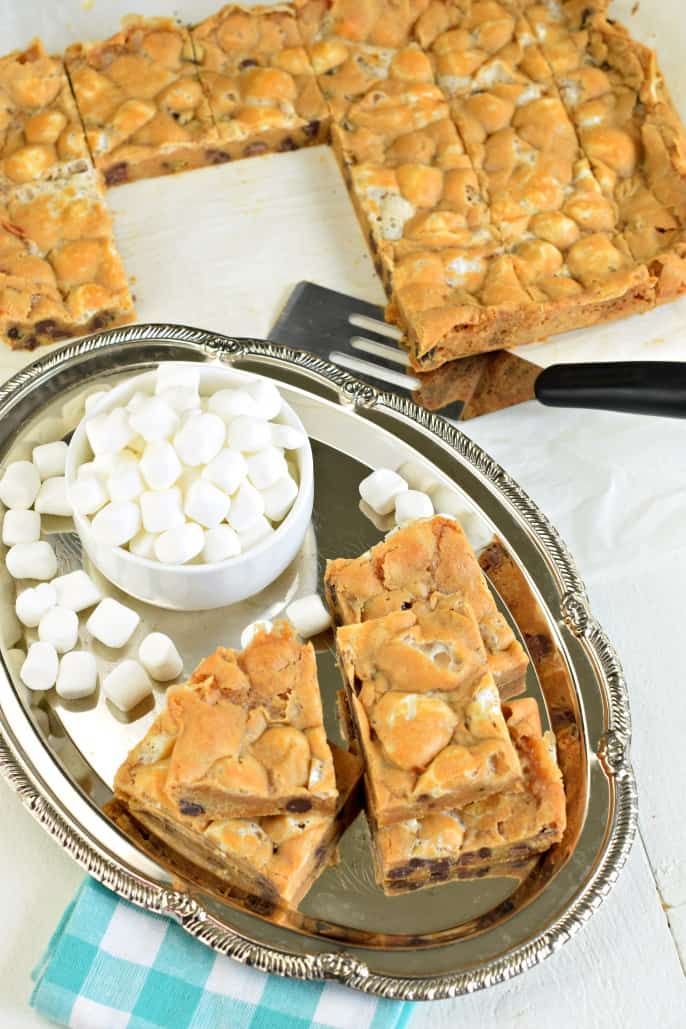 Chewy butterscotch bars on silver plate with mini marshmallows.