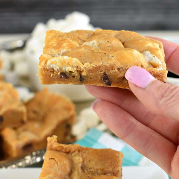 Hand holding a butterscotch s'mores bar.