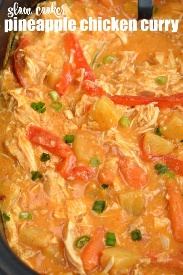 Pineapple chicken curry with red peppers and green onions in crockpot.