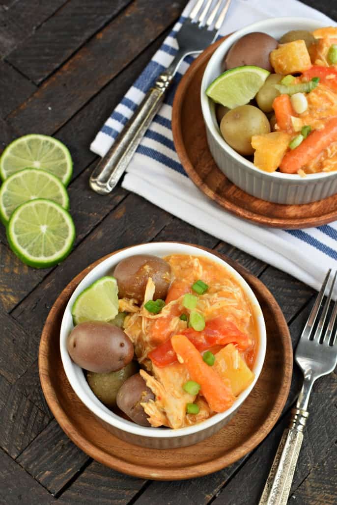 Overhead view of pineapple chicken curry in bowl with potatoes.