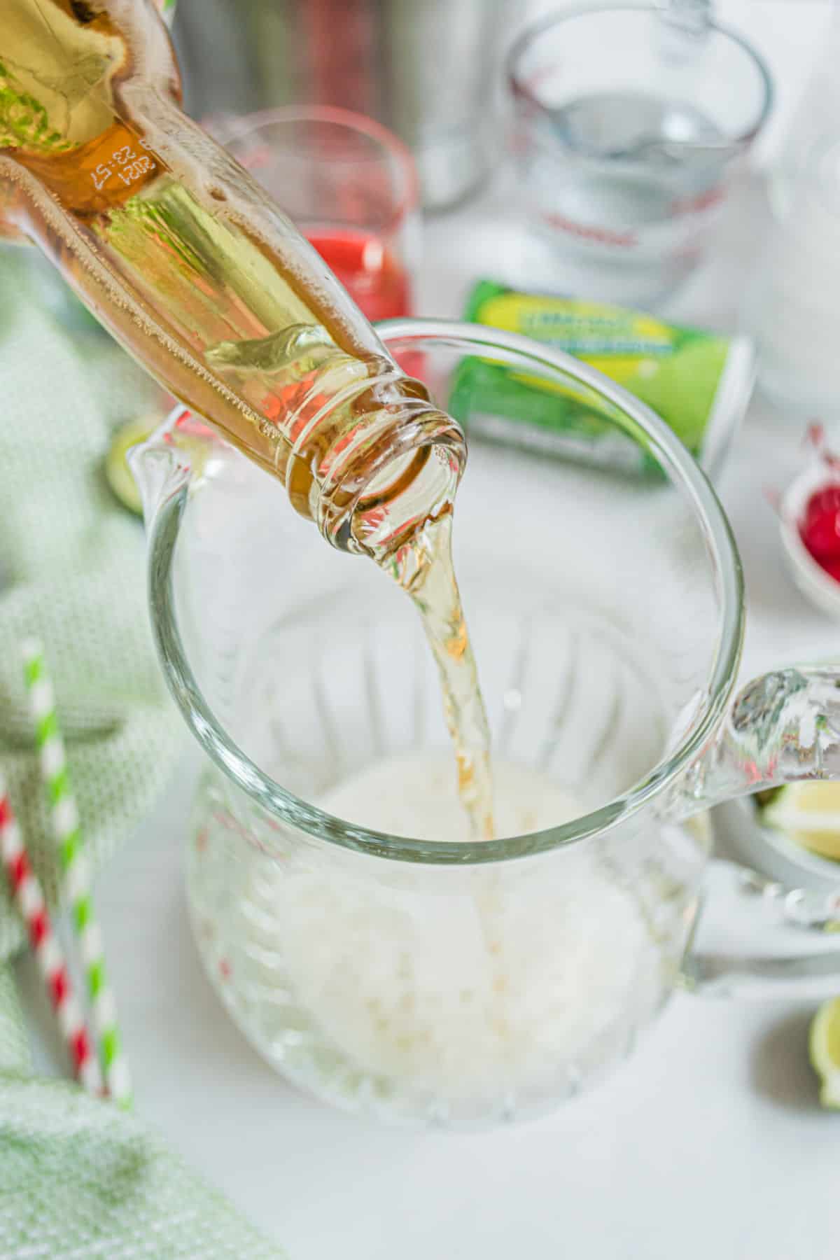 Pour beer into a pitcher for cherry beer margaritas.