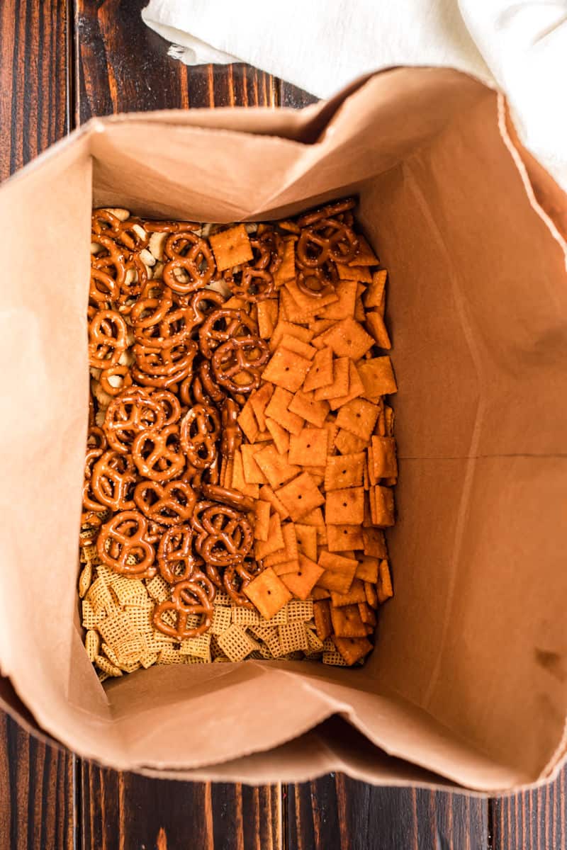 Paper bag with taco chex mix ingredients inside.