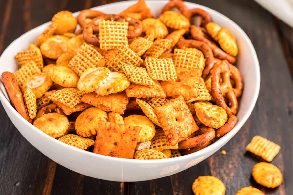 Taco chex mix in a white bowl.