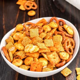 Spicy chex taco snack mix in a white bowl.