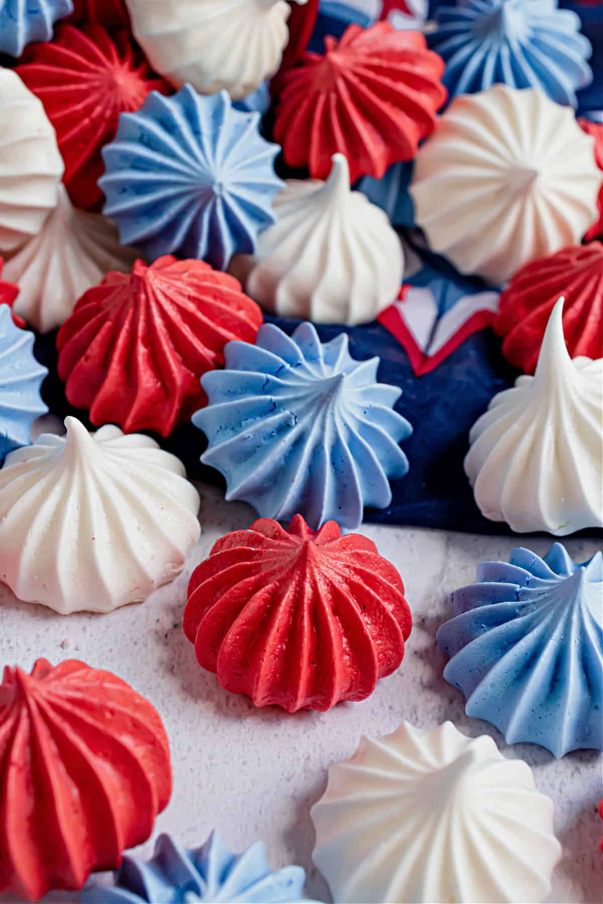 Red white and blue meringue cookies spilling out of a bucket.