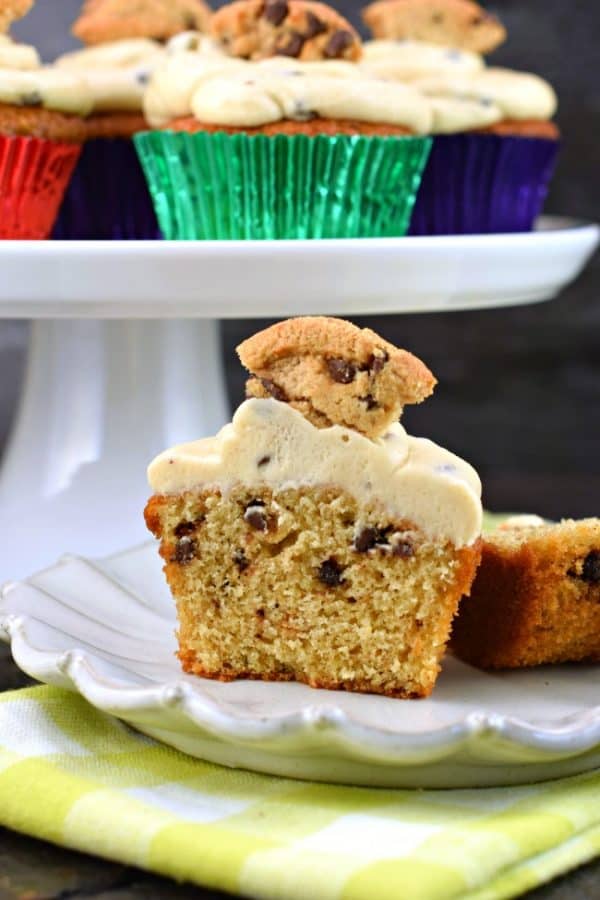 Chocolate Chip Cookie Cupcake with cookie dough frosting cut in half on a plate