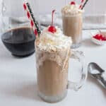 Homemade root beer float with whipped cream and a cherry.